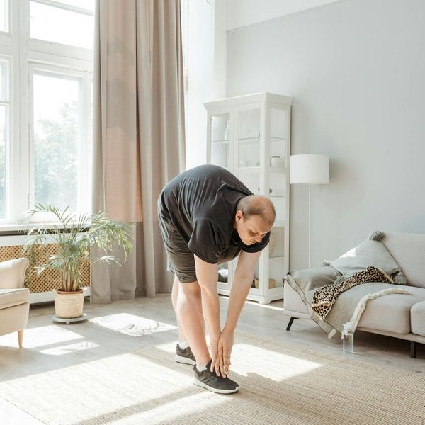 Stretching exercise demonstration in a bright room